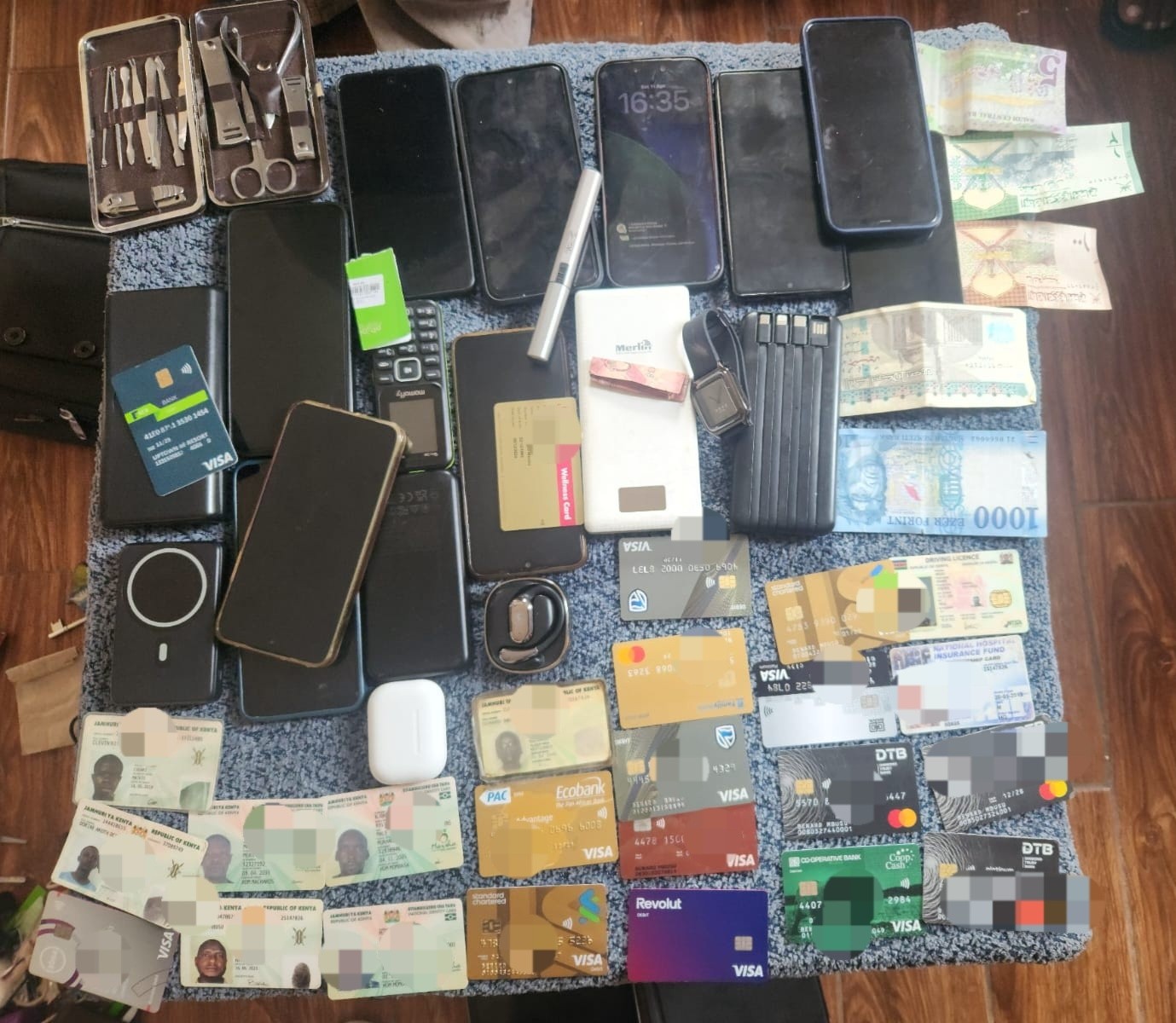 A search at a property led to the recovery of stolen items, including an HP laptop, mobile phones, assorted foreign currencies, multiple credit cards, cheque books from various banks and PDQ machines, Kenyan police said.