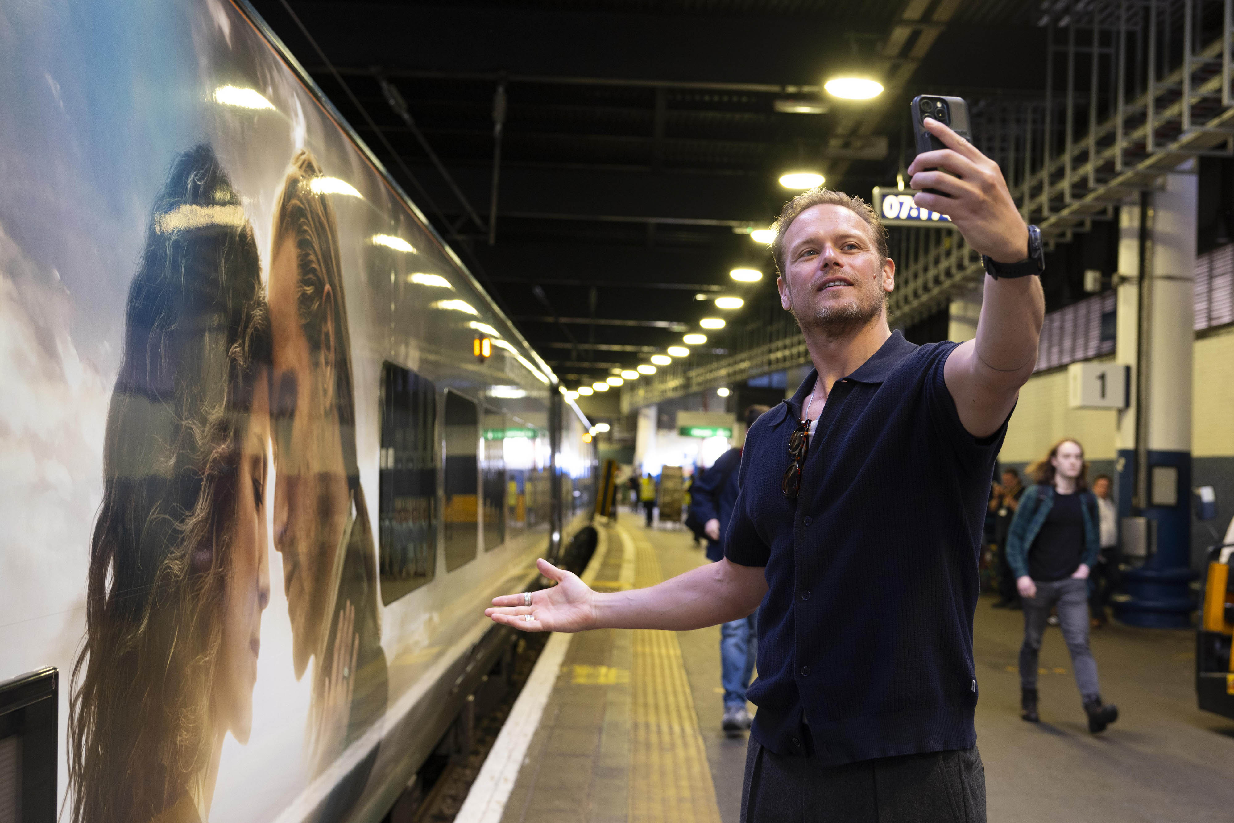 Sam Heughan unveils the Caledonian Sleeper's first full train wrap at London's Euston station.
