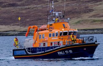 Man and dog rescued by lifeboat after getting stuck at foot of cliffs
