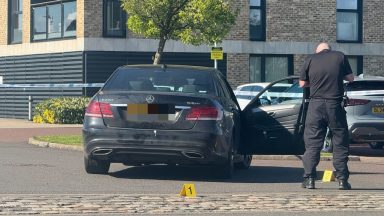Manhunt ongoing a week after pensioner ‘stabbed’ in car near Glasgow school