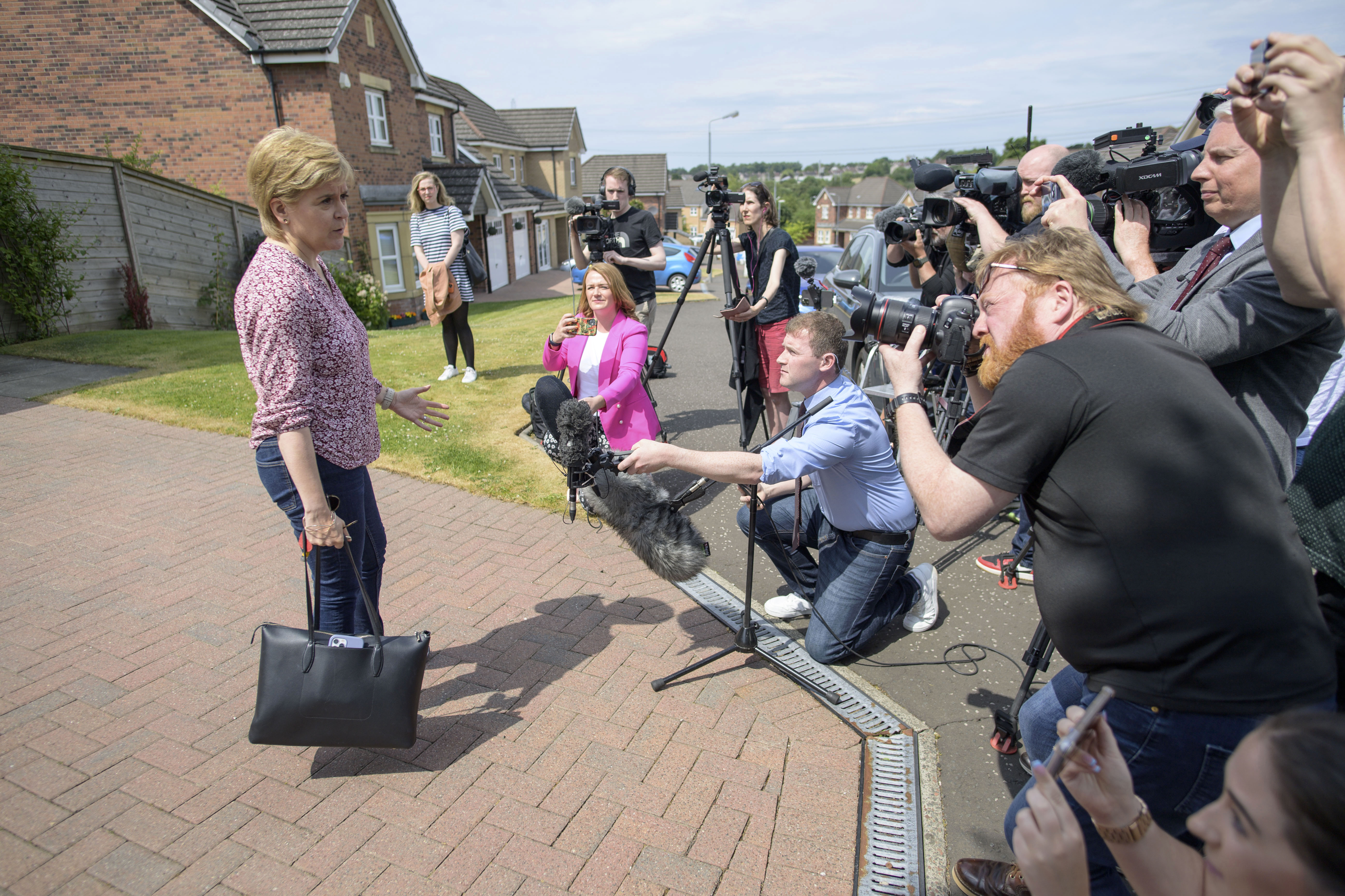 Former First Minister Nicola Sturgeon speaks to press outside her home on June 18, 2023 - a week after being arrestedand questioned by police.