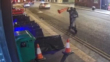 Two masked men on e-scooter throw traffic cone at rough sleeper in Glasgow