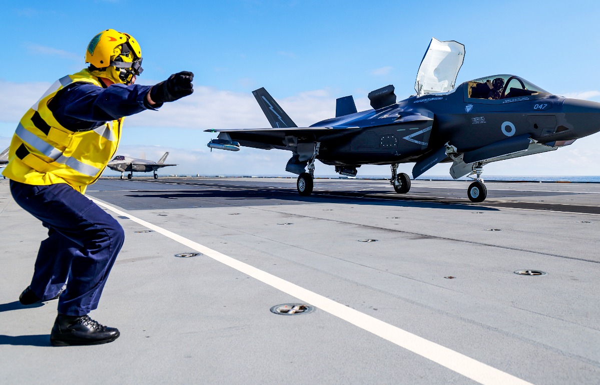 A F-35B fighter prepares to take off from HMS Prince of Wales to intercept a Russian Tupolev Tu-142 maritime reconnaissance and anti-submarine warfare (ASW) aircraft, NATO name 'Bear'