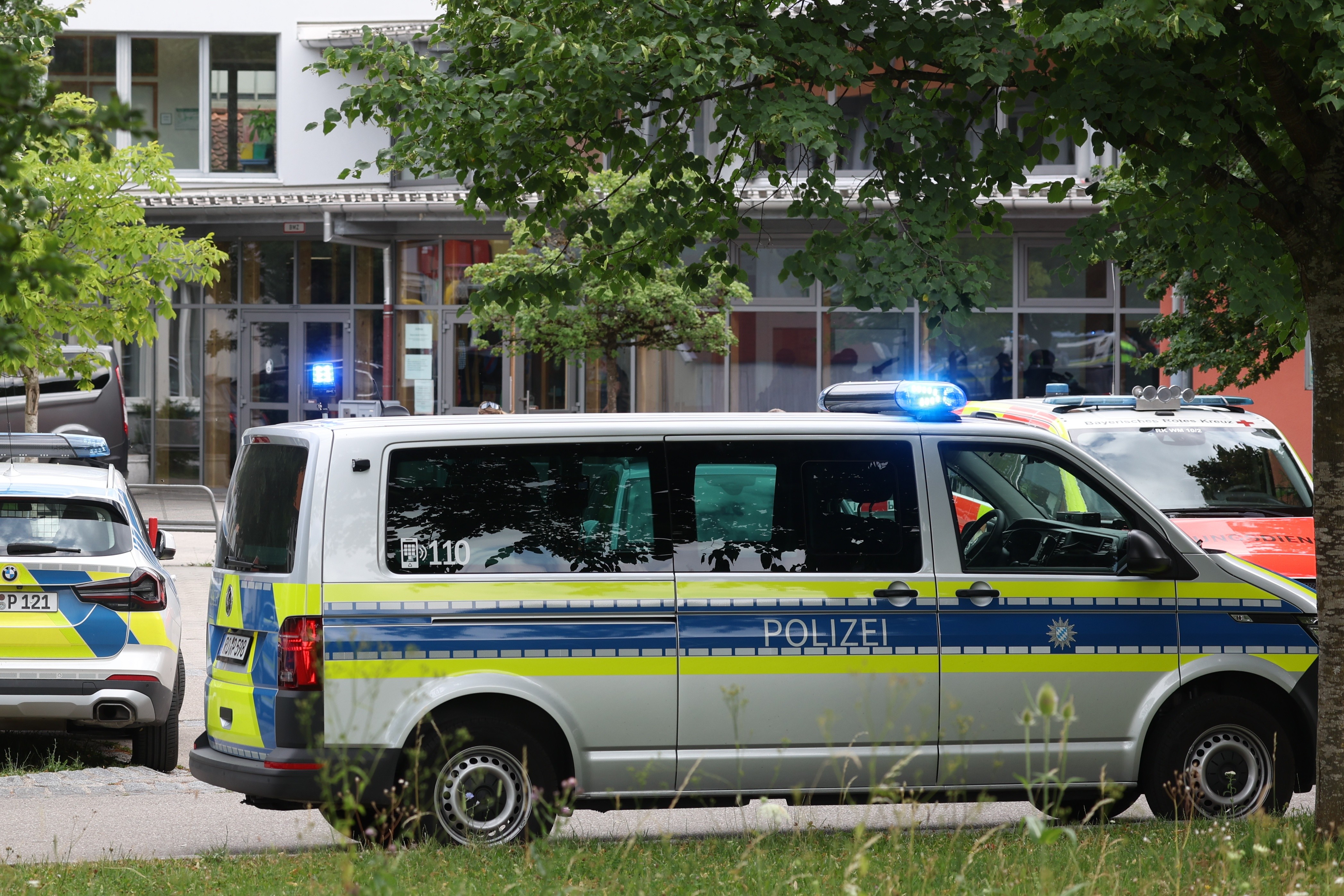 Police vehicles parked in front of the school