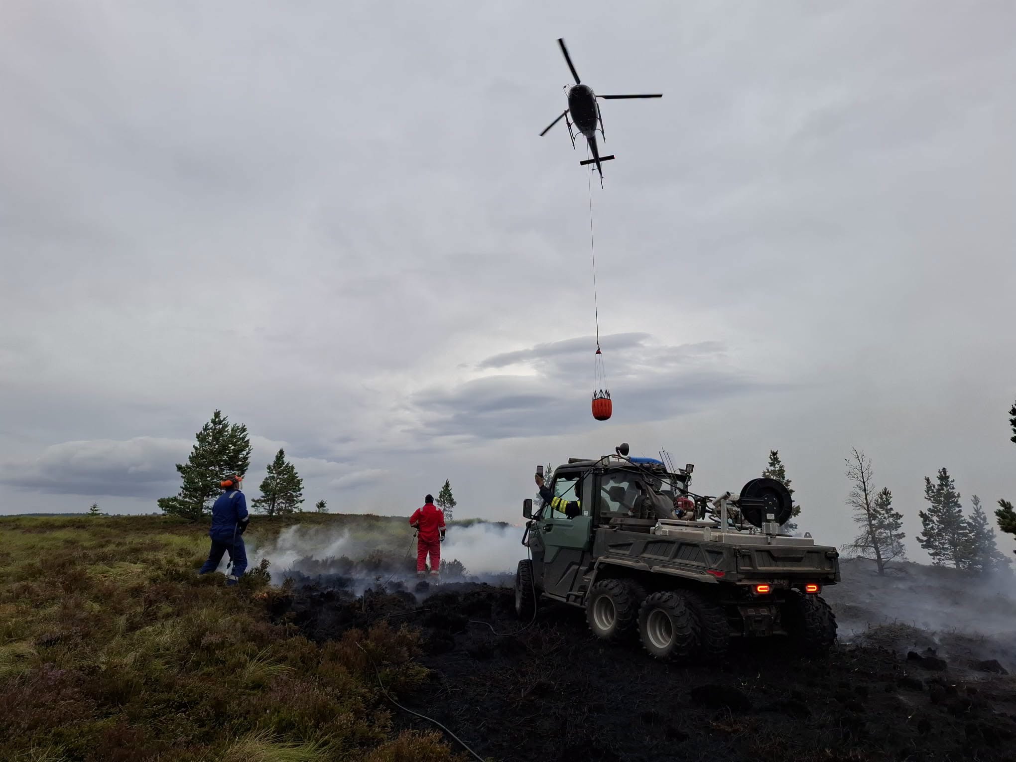 Helicopter carries water to help douse the wildfire in the Cairngorms.