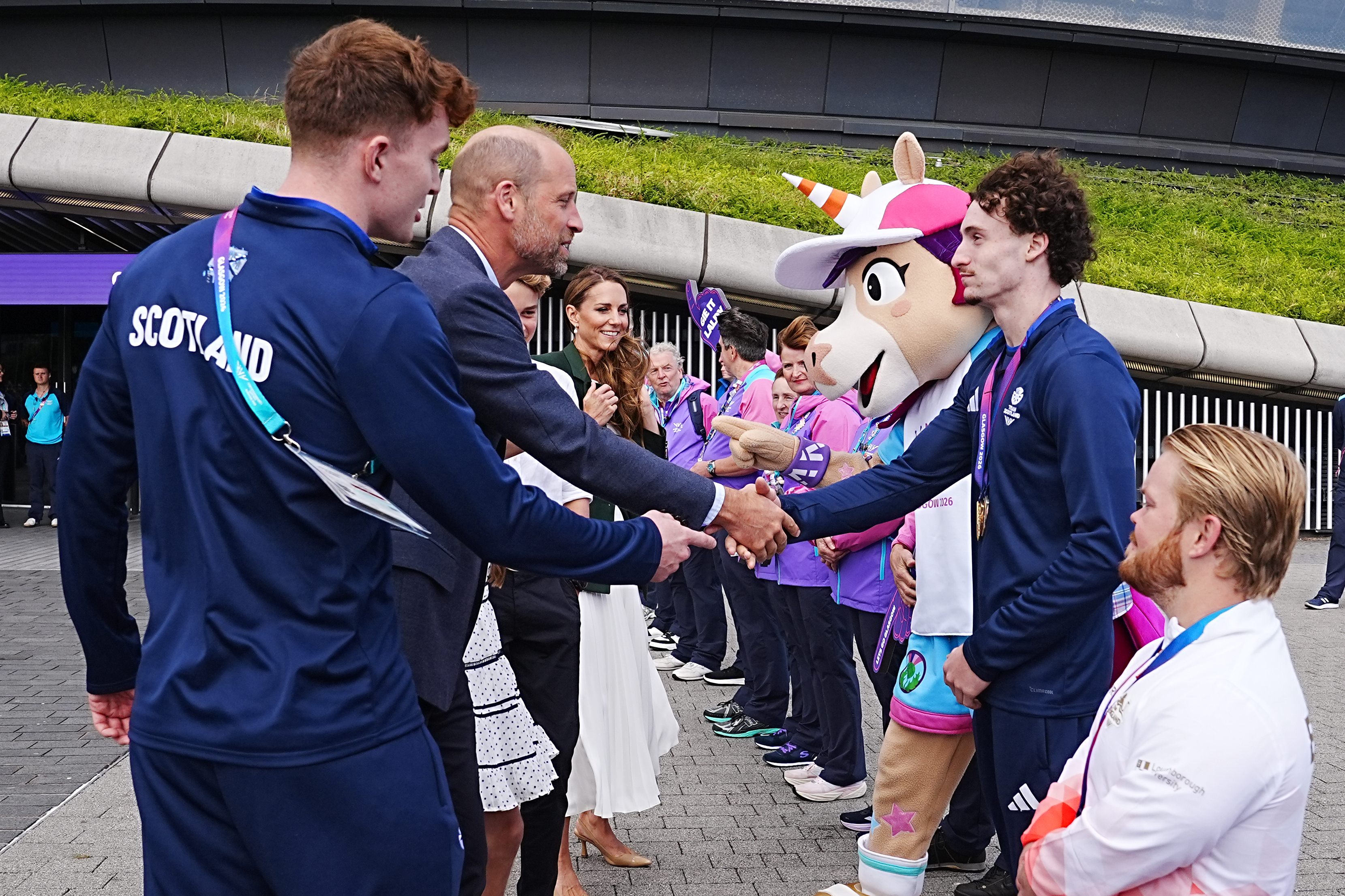 The Prince of Wales shakes hands with Scottish gymnast Reuben Ward, who won gold in the Men's Individual all-round gymnastics