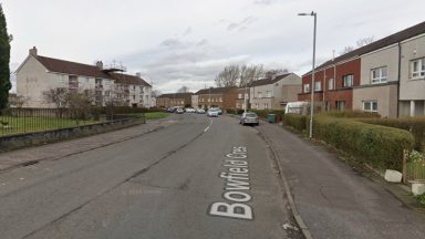 Glasgow property sealed off by police officers as man charged over alleged rape